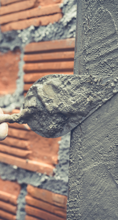 Bricklaying. Construction worker building a brick wall.